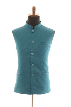 Introducing our exquisite Teal Self Embellishment Nehru Jacket for men, a true masterpiece that seamlessly marries classic style with contemporary sophistication. This carefully crafted Nehru jacket is a testament to the artistry and finesse that goes into creating a truly exceptional piece of menswear. The teal hue of this jacket exudes a sense of serenity and depth, making it an ideal choice for various occasions and skin tones. The rich color is further accentuated by the intricate self-embellishment patterns that adorn the jacket, adding a touch of refinement and uniqueness to your ensemble. Designed with a keen eye for detail, this Nehru jacket features a flawless fit and a comfortable silhouette that complements every body type. The Nehru collar elevates its regal appeal, while the f Classic Fitted Nehru Jacket For Ceremonial Occasions, Classic Nehru Jacket With Stand Collar For Wedding, Classic Nehru Jacket With Stand Collar For Festive Occasions, Festive Classic Nehru Jacket With Stand Collar, Nehru Jacket For Men, Nehru Jacket, Nehru Jackets, Mens Vests, Jacket For Men