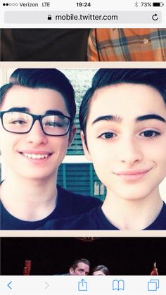 two people with glasses are smiling at the camera and one person is taking a selfie