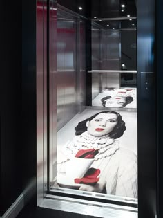 a display case with two women's faces painted on the glass and in red