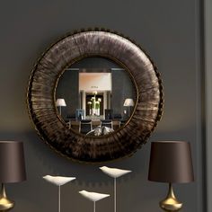 a living room with lamps and a mirror on the wall