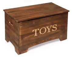 a wooden toy chest with the word toys on it's side and an open lid