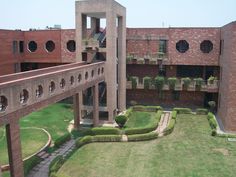 an aerial view of a building with many windows and plants growing in the courtyards