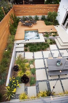 an aerial view of a small backyard garden with seating area and fire pit in the center