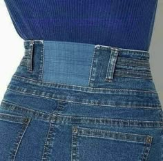 the back view of a woman's jeans with an inset logo on it