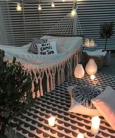 an instagramted photo of a hammock with pillows and lights on it