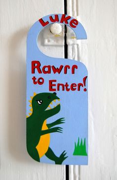 a door hanger with a dinosaur on it that says, luke rawr to enter