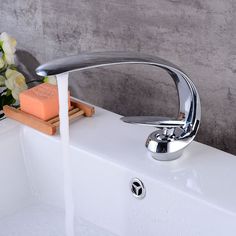 a faucet with soap and flowers in the background