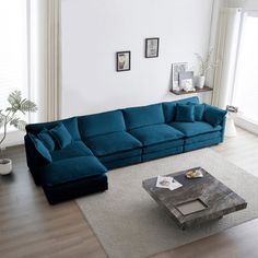 a living room with a large blue couch and coffee table in the middle of it