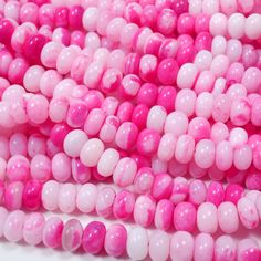 pink and white beads are stacked together