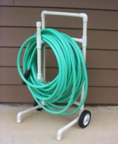 a hose cart with a green hose attached to it