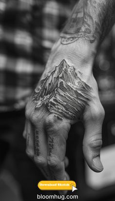 a man with a mountain tattoo on his hand