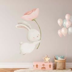 a wall with balloons and a bunny holding a flower