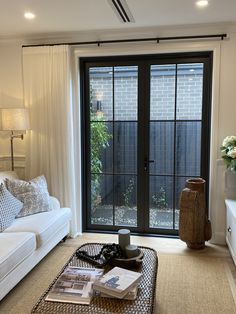 a living room filled with furniture and a sliding glass door