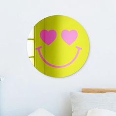 a bedroom with a smiley face mirror on the wall