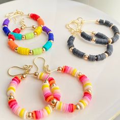 three different colored bracelets sitting on top of a white table next to each other