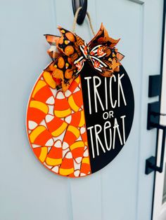 a trick or treat door hanger hanging on a door