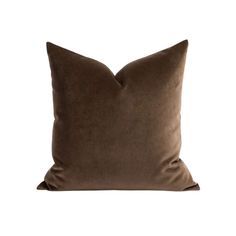 a brown pillow on a white background