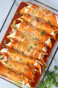 an enchilada dish in a glass casserole dish with cilantro and parsley