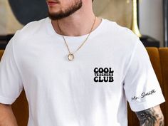 a man wearing a white t - shirt with the words cool tiger club on it