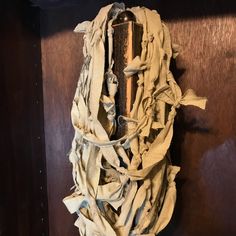 a piece of cloth hanging on the side of a wooden door