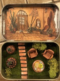 two tin trays filled with miniature garden items