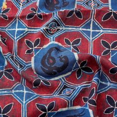 a red and blue patterned cloth with an image of a monkey on the front side