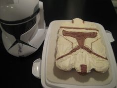 a star wars themed cake sitting on top of a counter next to a helmet and microwave