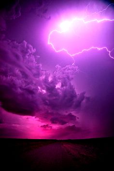 a lightning bolt is seen in the sky above a field