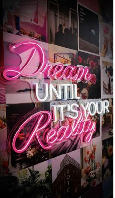 the words dream until it's your reality are lit up against a wall covered in photos