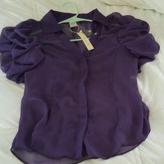 Size Small 100% Poyester Ruffled Sleeve Sheer Blouse. Hidden Buttons If Buttoned Up. New With Tag And Extra Button. Formal Purple Summer Blouse, Elegant Sleeveless Blouse With Buttons, Chic Purple Blouse With Buttons, Purple Sleeveless Blouse For Spring, Chic Purple Buttoned Blouse, Purple Relaxed Fit Button Blouse, Cheap Purple Button-up Tops, Chic Purple Button-up Blouse, Purple Button-up Outerwear With Button Closure