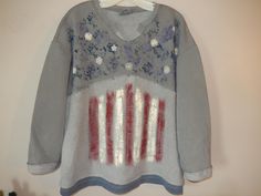 This unique light weight v neck patriotic sweatshirt is a must be added to the wardrobe top!   The top is the gray sweatshirt with splotches of navy-blue paint with little stars and dainty daisy's.  The second section is inside out and painted with dark red and cream stripes to represent our flag.  The bottom has a navy blue trim that looks like it's a layered t shirt under the sweatshirt.  This classy Americana tee could be worn with your favorite pair of jeans or a pair of leggings.  This lightweight sweatshirt is so soft and overflowing with comfort that you will think you are in your pjs!  The most premium sweatshirt you can get your hands on. You will want to live in this.  Great gift idea too! Please note, while I do my best to capture highest quality pictures, the color may very sli Patriotic Sweatshirt, Navy Blue Paint, V Neck Tunic, Layered T Shirt, Gray Sweatshirt, Blue Trim, Quality Pictures, The Gray, Blue Paint