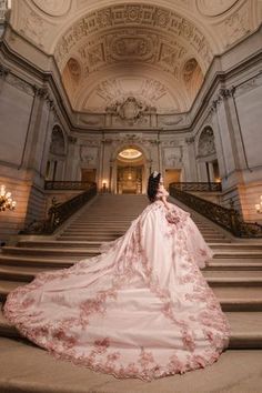 a woman in a wedding dress standing on some stairs