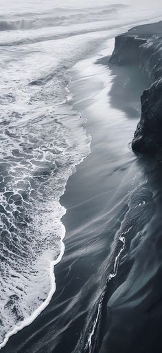 black and white photograph of waves on the beach