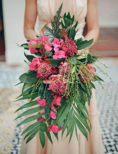 a woman in a dress holding a bouquet of flowers