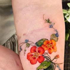 a close up of a person's arm with flowers on it