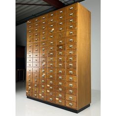 a large wooden filing cabinet with many drawers