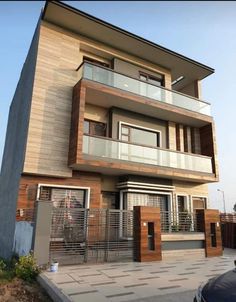 a two story building with balconies on the second floor