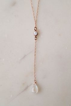 Our SKYE Moonstone Necklace is so dainty & beautiful! This dainty lariat necklace is made for the minimalist lovers who want something that they can wear on their special day without overpowering their entire look. The eye catching cubic zirconia and rainbow moonstone add an elegant touch to a classic look. ---------------------FEATURES◊ Your choice of material: 14k gold fill, rose gold fill, or sterling silver◊ Cubic zirconia (4mm) set in gold fill, rose gold fill, or sterling silver ◊ Hand Wedding Gemstone Lariat Necklace, Elegant Moonstone Clavicle Chain Jewelry, Dainty Teardrop Backdrop Necklace As Gift, Delicate Rose Gold Lariat Necklace Gift, Dainty Rose Gold Long Drop Jewelry, Delicate Rose Gold Lariat Necklace, Elegant Adjustable Moonstone Necklaces, Elegant Adjustable Gemstone Lariat Necklace, Elegant Adjustable Moonstone Necklace