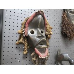 a metal mask hanging on a wall