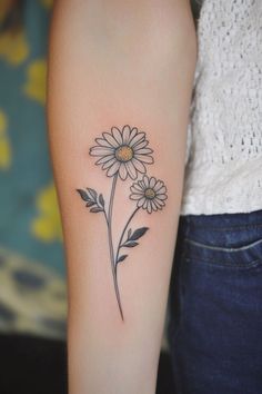 Two daisy flowers tattooed on an arm. Daisies Tattoo, Tattoo Daisy