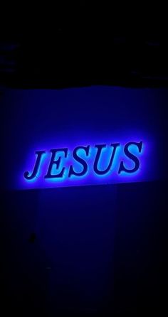 the word jesus is lit up in blue light