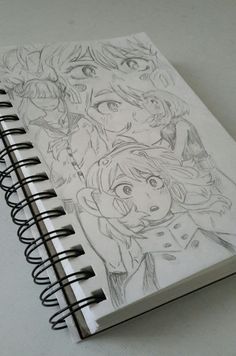 an open notebook with some drawings on it