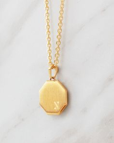 Modern and minimal. The gold Combine Pendant is a versatile piece to add to your collection, perfect to elevate any look, day or night. This men's pendant has eight sides and tapered edges for a clean geometric design. Minimalist Gold Locket Necklace With Adjustable Chain, Gold Hexagon Necklace For Formal Events, Gold Hexagon Necklace For Formal Occasions, Minimalist Yellow Gold Medallion Locket Necklace, Minimalist Yellow Gold Locket Necklace, Minimalist Octagon Jewelry For Everyday, Gold Engraved Octagon Jewelry, Minimalist Engraved Pendant Locket Necklace, Engraved Minimalist Pendant Locket Necklace