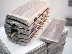 stacks of newspapers stacked on top of each other with clothes pins sticking out of them