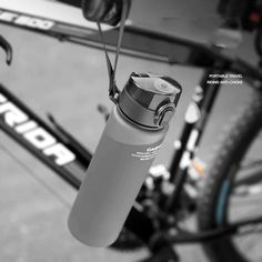 the water bottle is attached to the handlebars of a bicycle