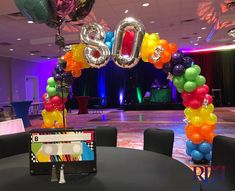 the balloon arch is decorated with balloons and letters that spell out'80's