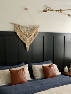 a bedroom with black paneled walls and white bedding