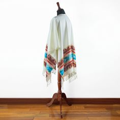 This luxurious alpaca wool poncho-wrap will fit you perfectly. This gorgeous poncho features a unique design. Our alpaca wool poncho is very soft to touch. The poncho measures a total of approximately 166 cm (65 inches) wide and 126 cm (50 inches) from the neck to the bottom, including the fringe. One size fits all. Weigth: 450 gr Due to handmade nature of the ponchos patterns and colour shades may vary. Material is a blend of Alpaca wool and cotton. The alpaca is a product of ancient Andean civ Ruana Wrap, Colour Shades, Poncho Wrap, Poncho Shawl, Wool Poncho, Poncho Pattern, Alpaca Fiber, The Fringe, Poncho Cape