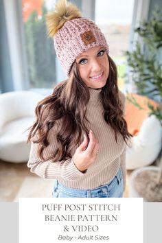 a woman wearing a knitted beanie hat with pom - pom on it