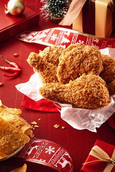 some fried food sitting on top of a table next to crackers and christmas decorations